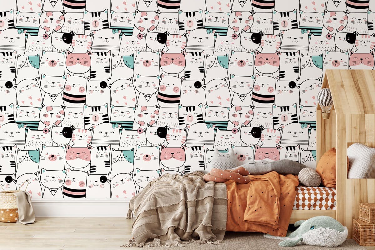Whimsical Cats Pattern Wallpaper in pastel nursery with wooden bed and cosy textiles. Playful decor.