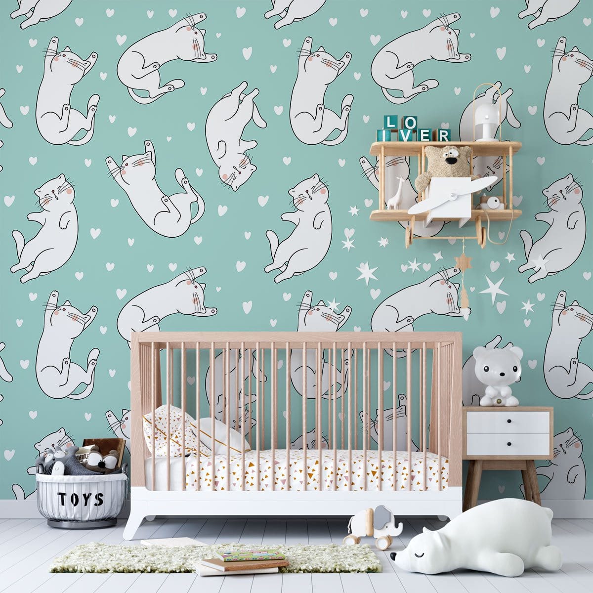 Playful white cats wallpaper, mint green background; nursery style, wooden crib, mint wall, playful vibe.