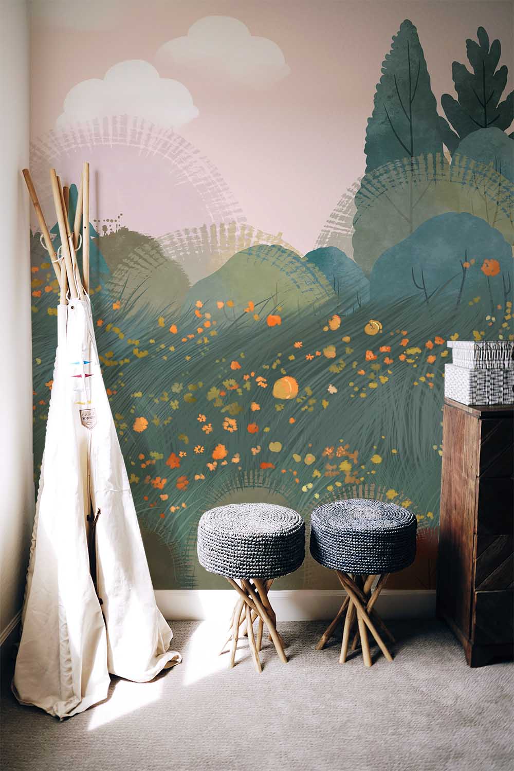 Serene Pastel Forest Mural Wallpaper in room with grey stools, wooden chest, and soft carpeting.