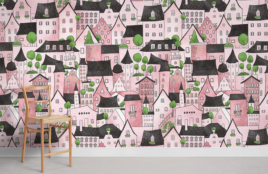 Charming pink village fantasy mural wallpaper with green accents in a room with wooden chair.