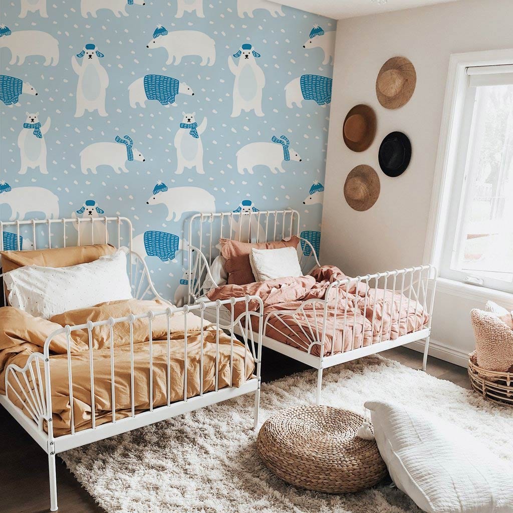 Children's room with Charming Arctic Polar Bears wallpaper, white beds, cosy rug, and wicker basket.