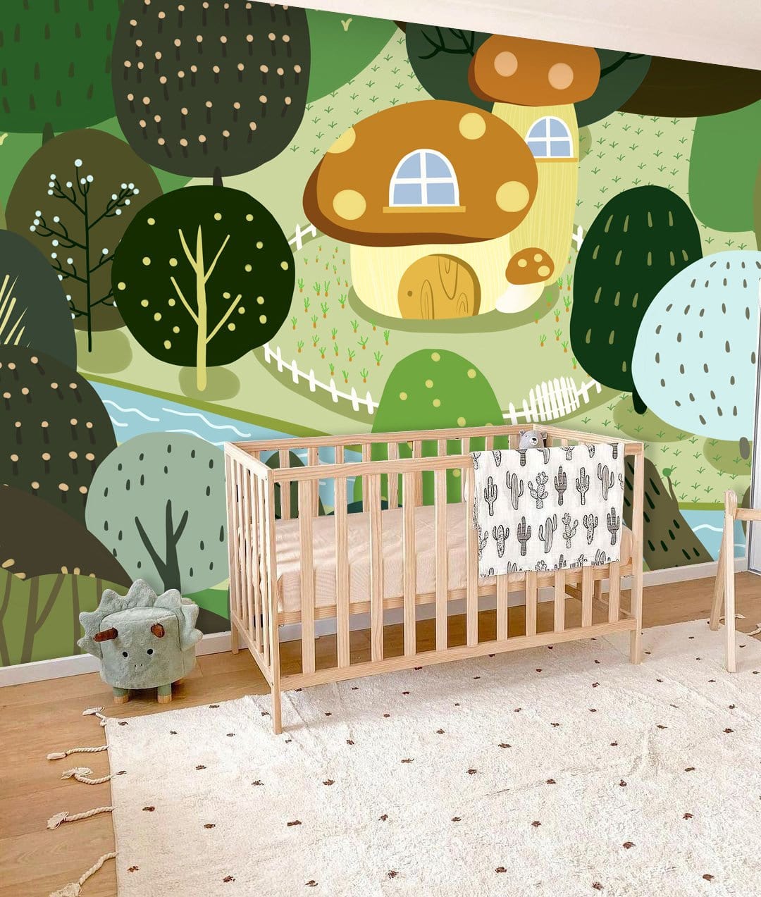 Nursery with Whimsical Mushroom Cottage Forest Wallpaper, wooden crib, plush toy, white polka dot rug.