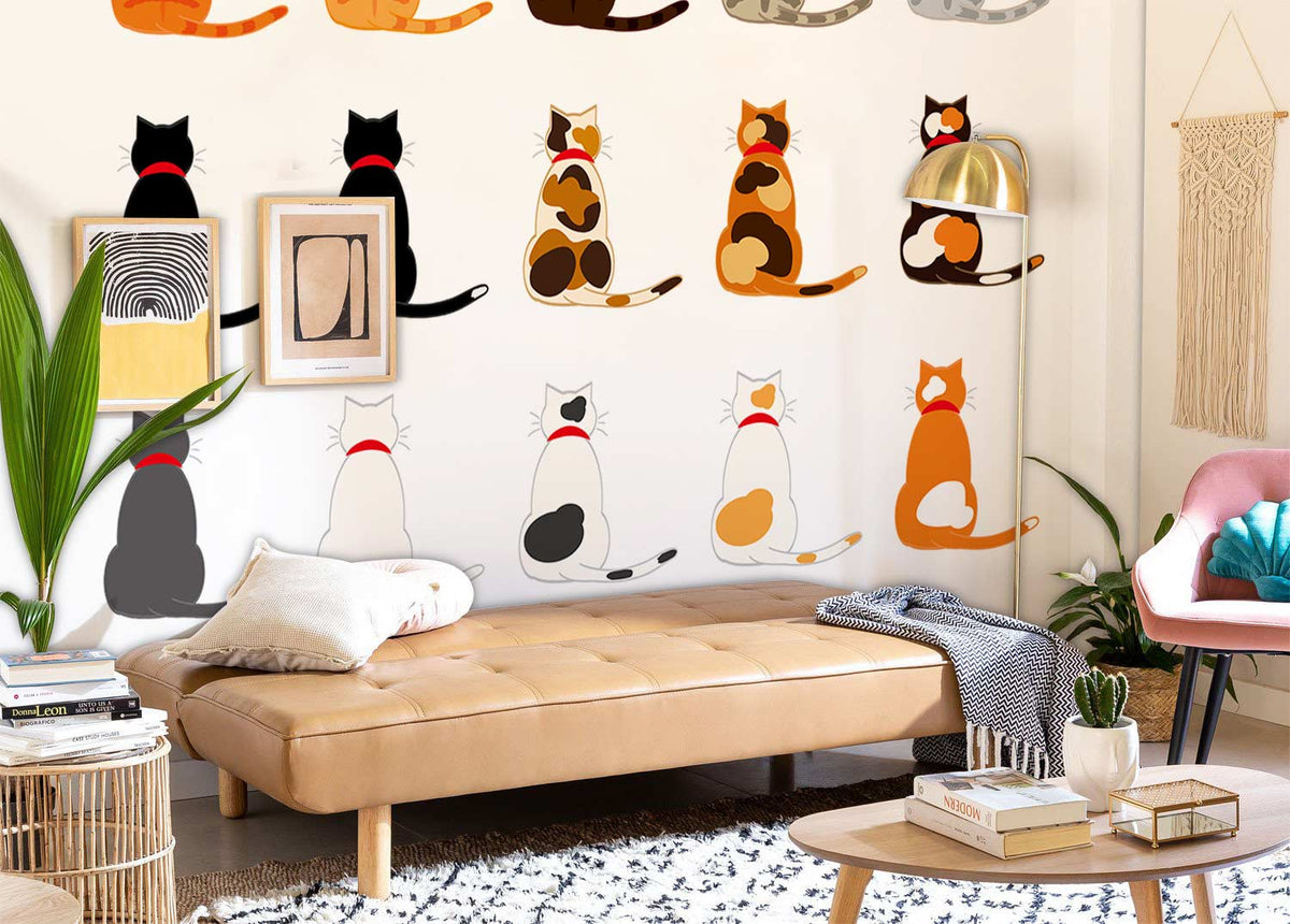 Multicolour playful feline wallpaper with tan leather sofa, modern decor, in stylish living room setting.