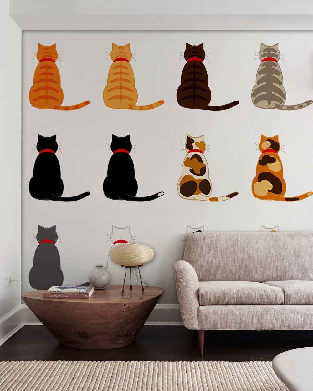 Charming cat wallpaper in cosy living room with modern grey sofa, wooden table, white walls.