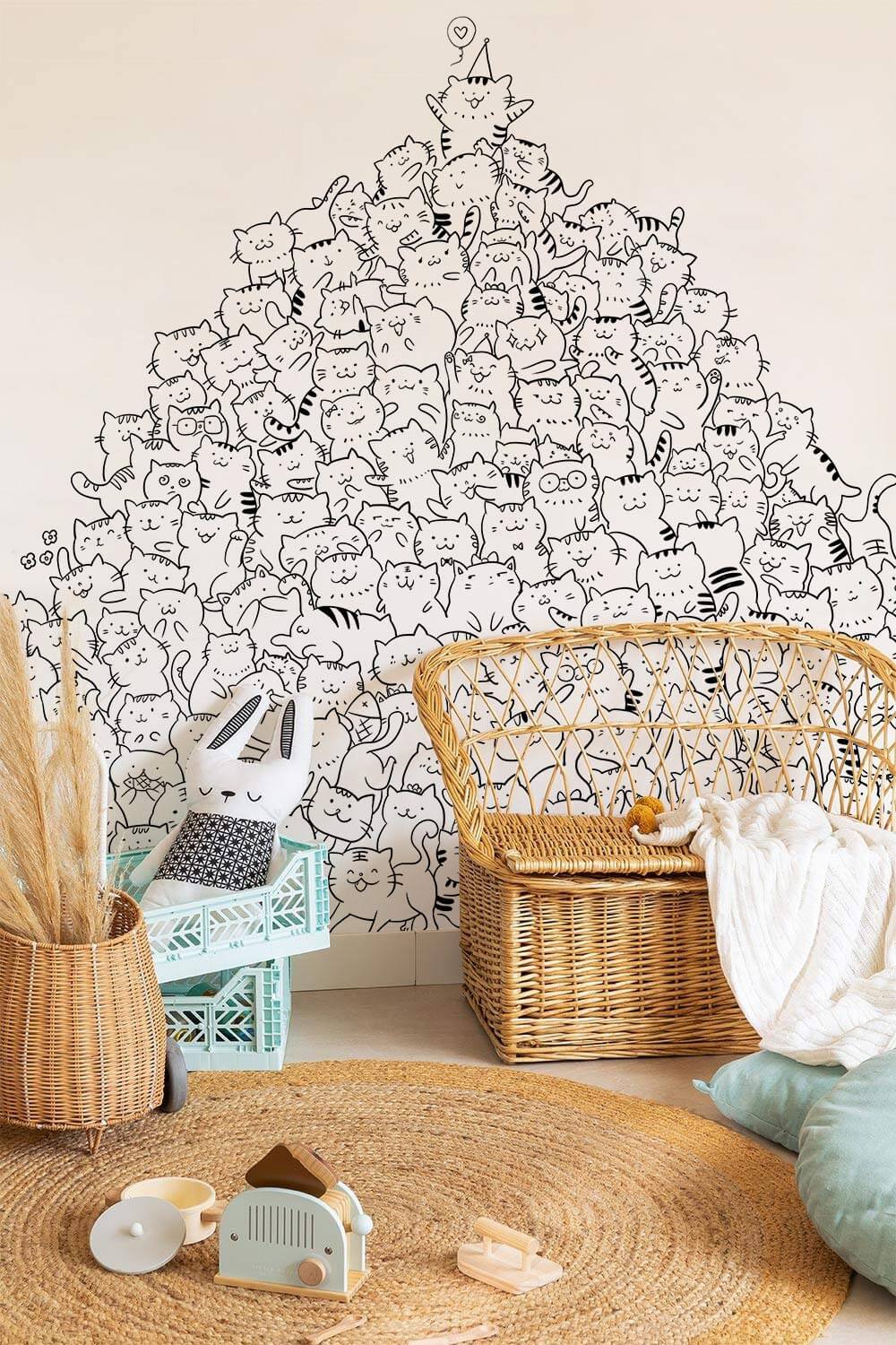 Charming Black and White Cat Doodles mural; wicker chair, neutral wall, round woven rug, children's room.