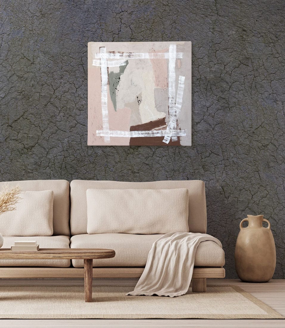 Beige sofa and wooden table with textured cracked earth effect wallpaper in rustic living room.