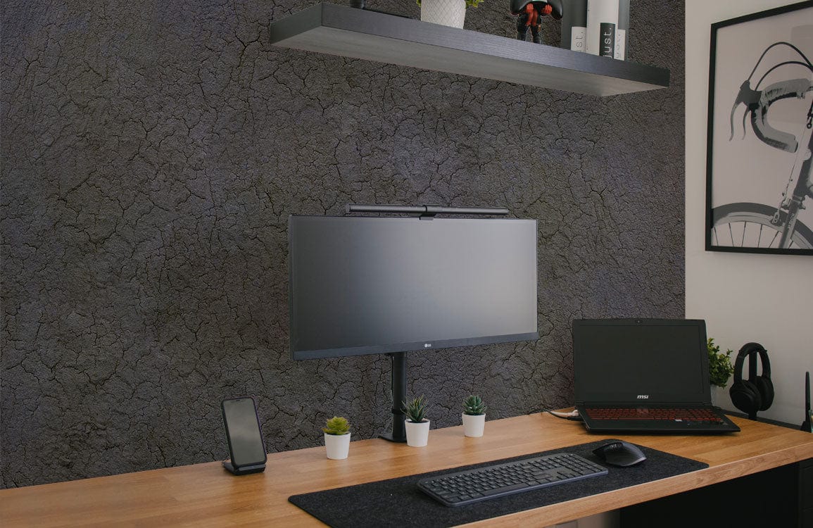 Rustic office with grey textured cracked earth effect wallpaper, wooden desk, and minimalist decor.