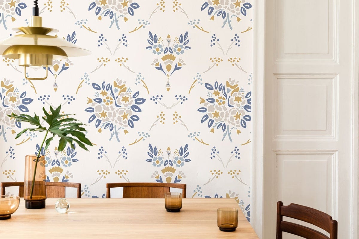 Vintage floral wallpaper in soft blue and gold tones, wooden dining table, and chairs in dining room.
