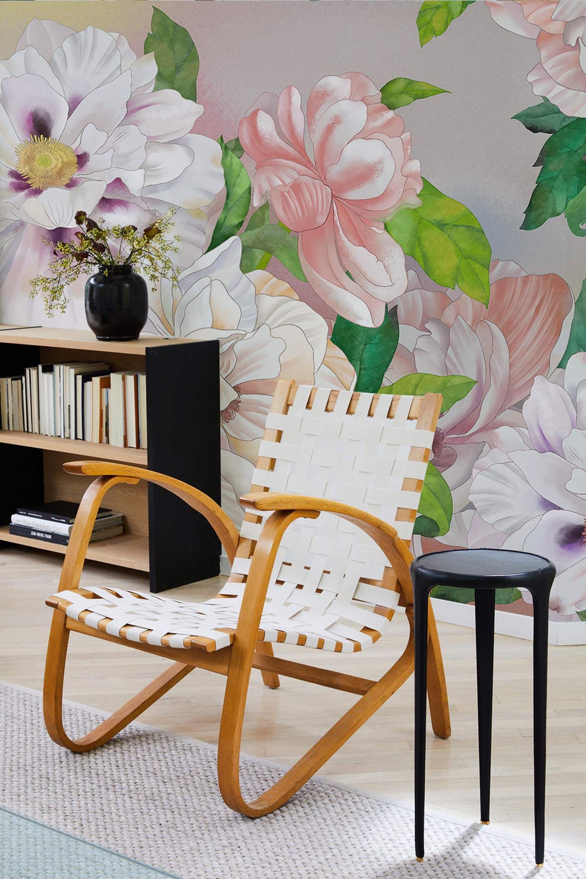 Elegant Floral Paradise Mural Wallpaper in soft pastel colours, wooden chair, light wood flooring.