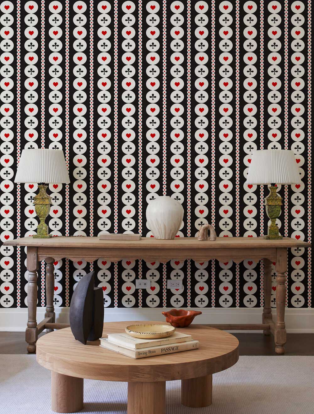 Retro black and white geometric circles wallpaper with red accents, wooden tables, neutral lamps, modern decor.