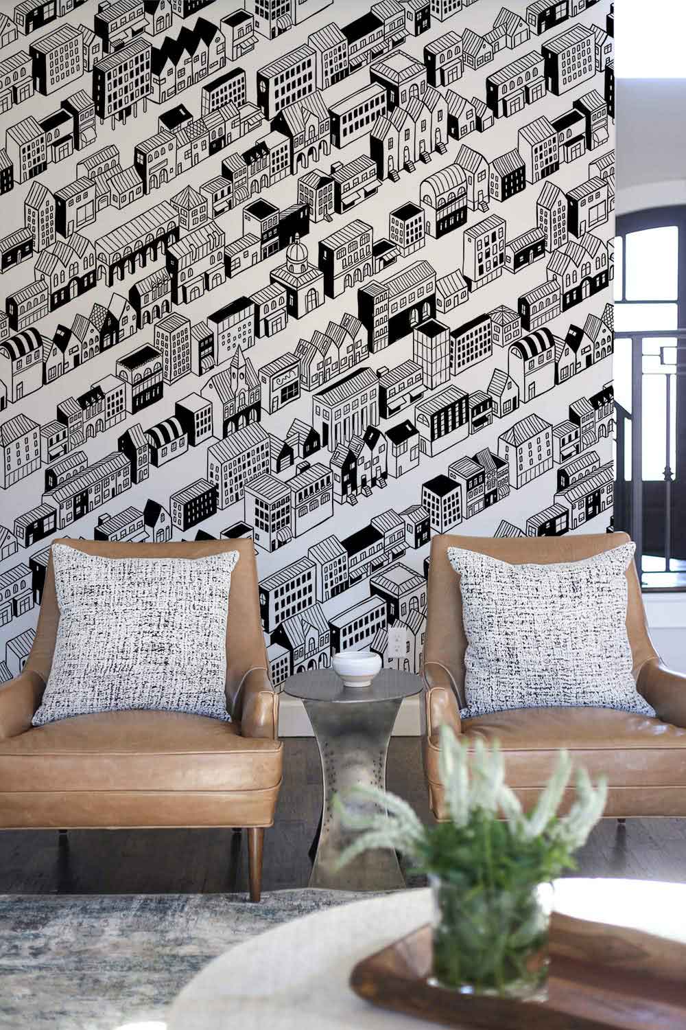 Monochrome urban architecture wallpaper, black sofas, grey flooring, stylish contemporary room decor, framed windows.