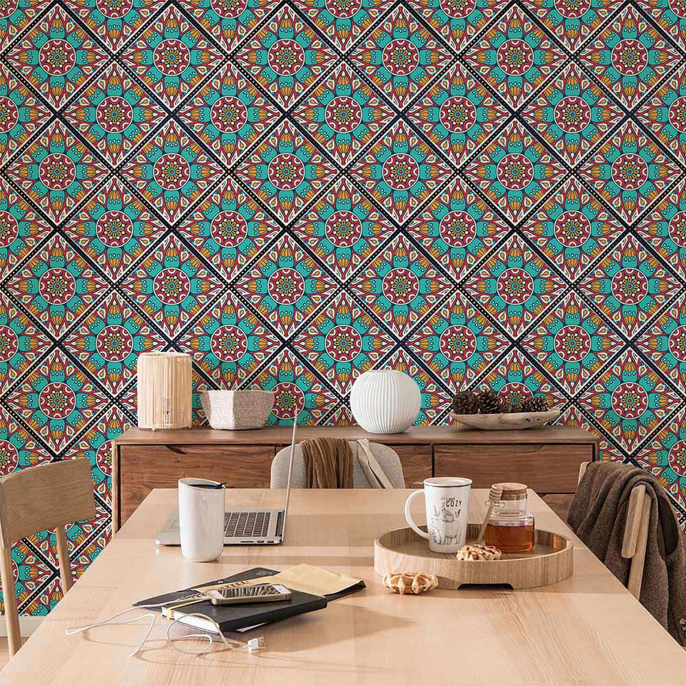 Vibrant geometric mosaic wallpaper in teal, red, beige with wooden dining furniture and neutral decor.