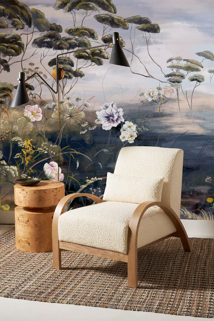 Tranquil Woodland Floral Mural Wallpaper with textured armchair, wooden side tables, and contemporary lighting.