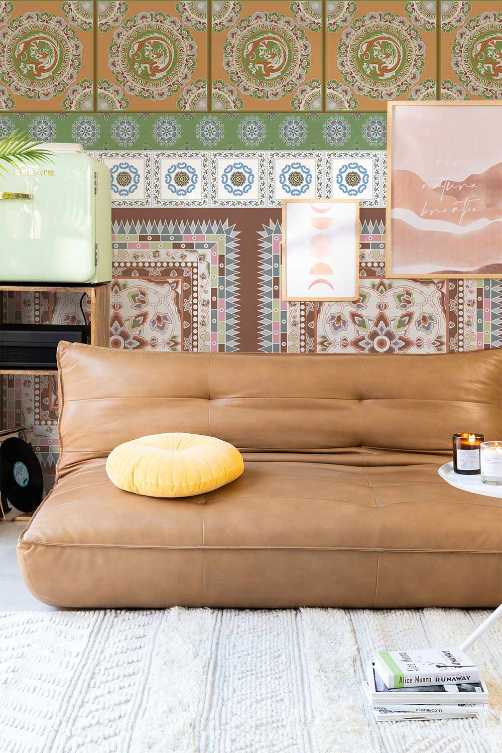Vintage Earth Tones Geometric Elephant Wallpaper in living room with brown leather sofa and modern art.