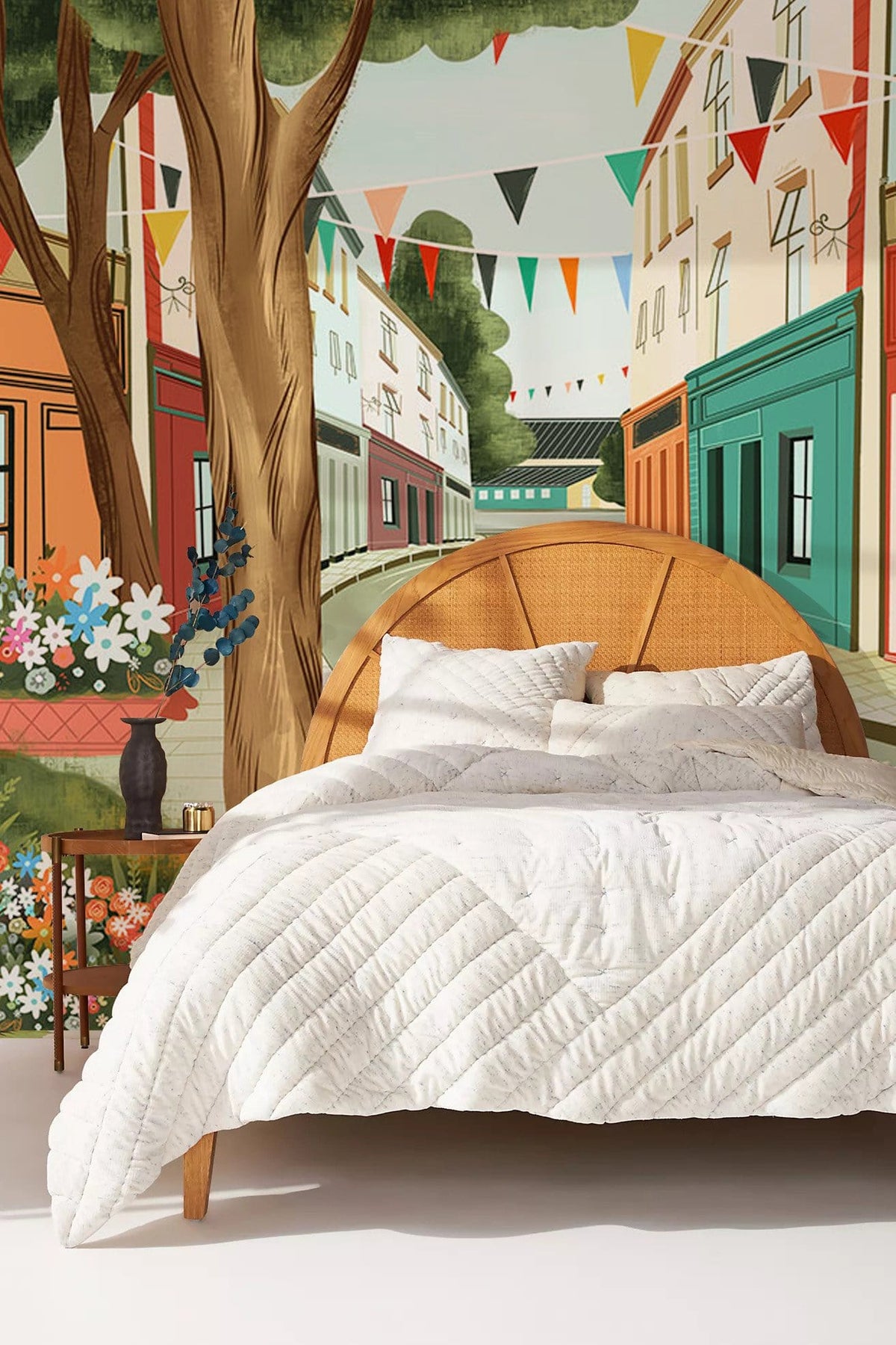 Bed with Charming Vintage Village Bicycle Scene Mural Wallpaper; colourful street, flags, wooden bedframe.