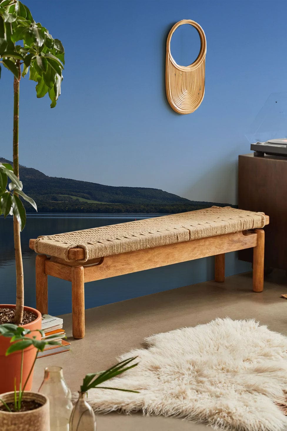 Tranquil Blue Lake Mural Wallpaper with rustic bench, beige rug, living room, oval wall mirror.