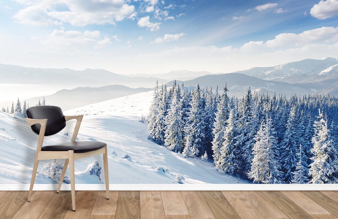 Scenic Winter Wonderland Snowy Mountain Forest Mural Wallpaper with chair, wood flooring; elegant wall decor.