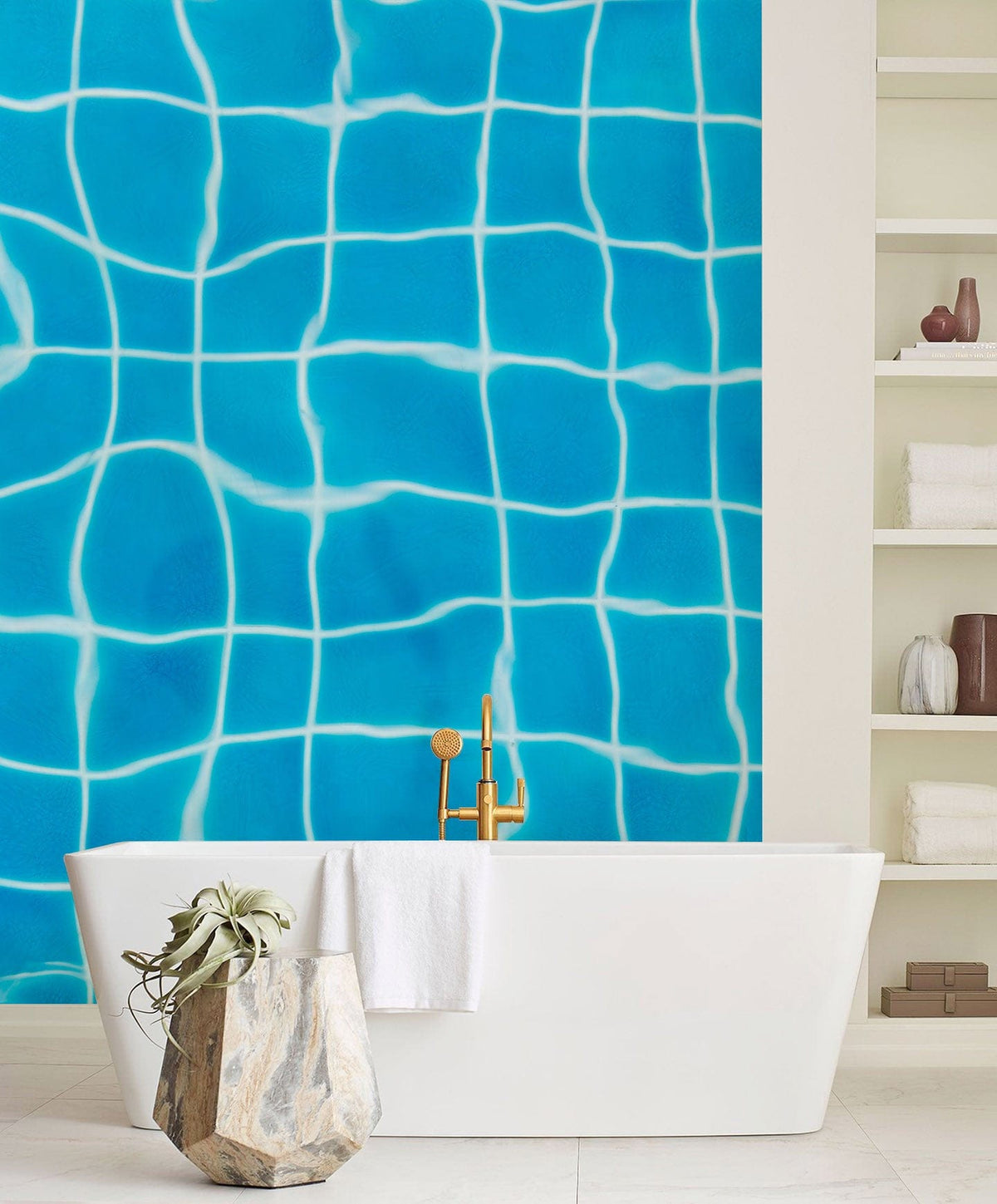 Aqua Blue Rippling Water Grid Wallpaper in modern bathroom with white freestanding bathtub and shelving.
