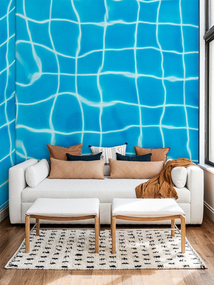 Aqua Blue Water Grid Wallpaper in modern living room with white sofa and wooden flooring.