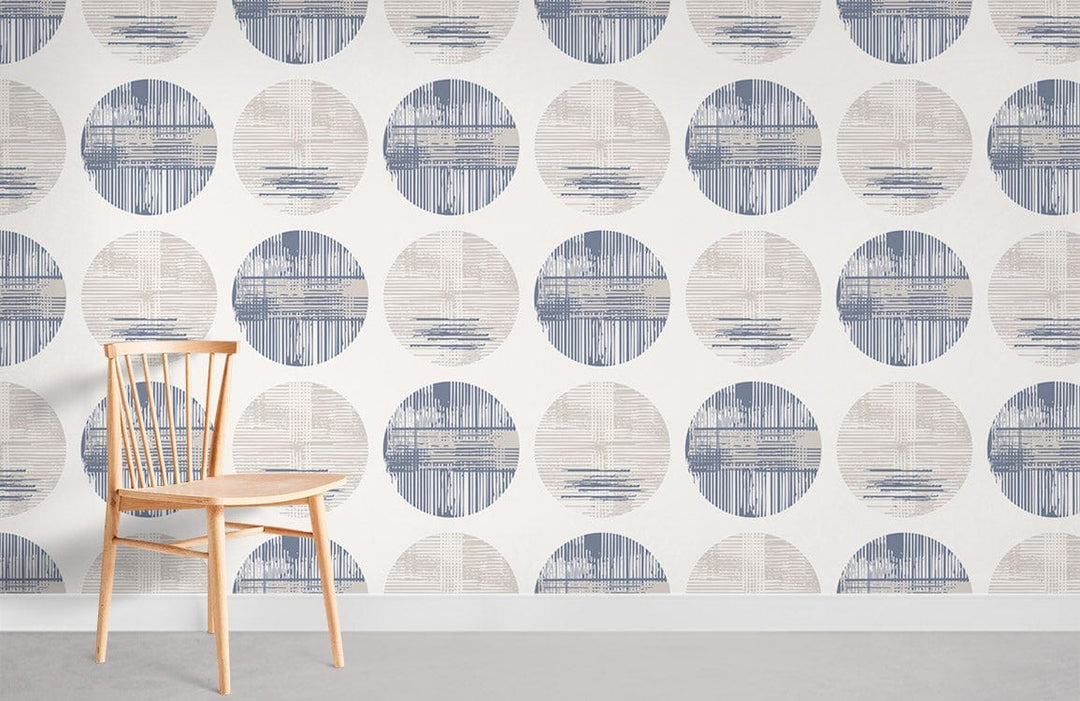 Modern geometric circles wallpaper in blue and beige; wooden chair, grey flooring, contemporary design.