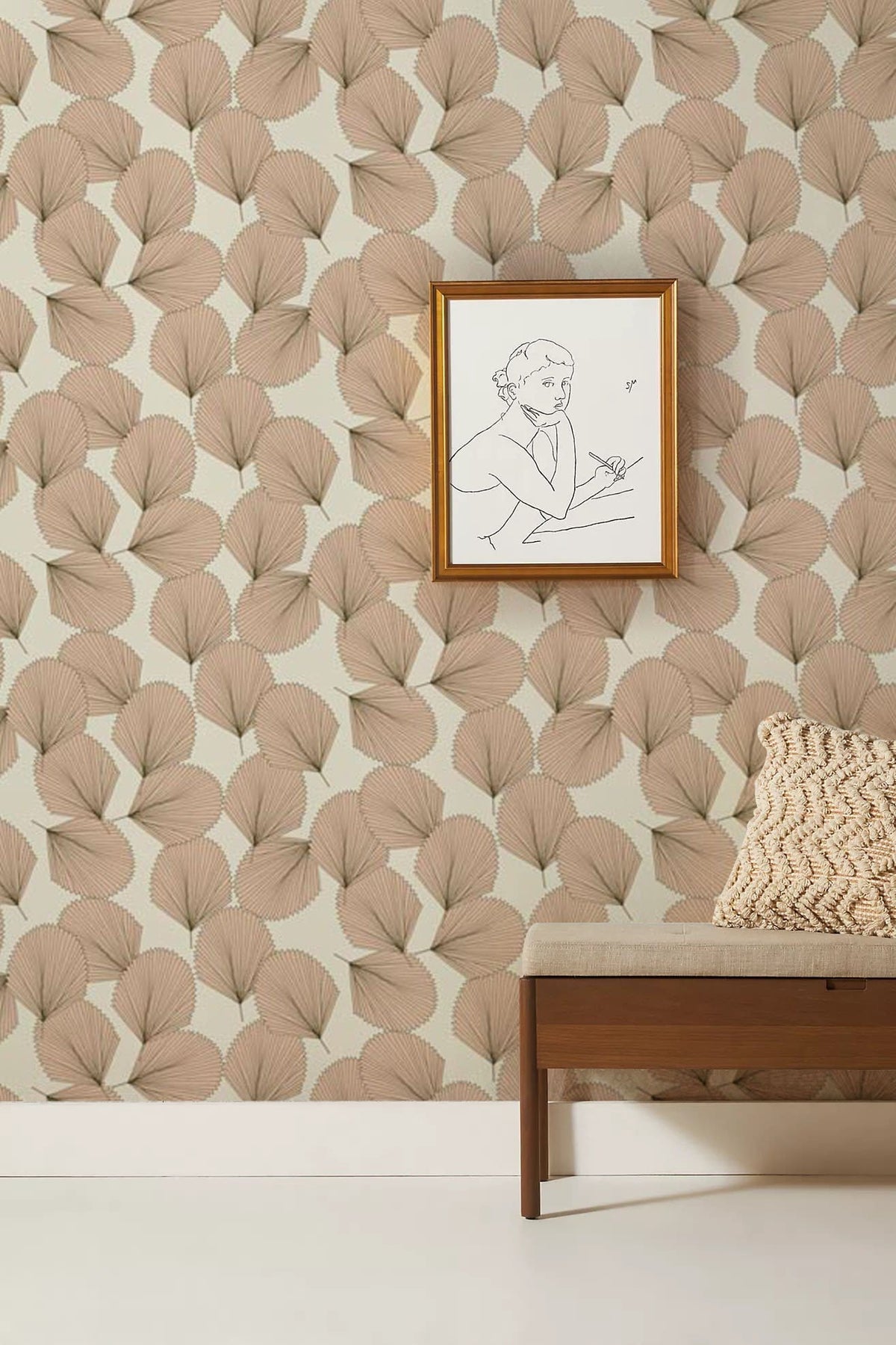 Elegant beige leaf wallpaper in modern room with framed art, wooden bench, and patterned cushion.