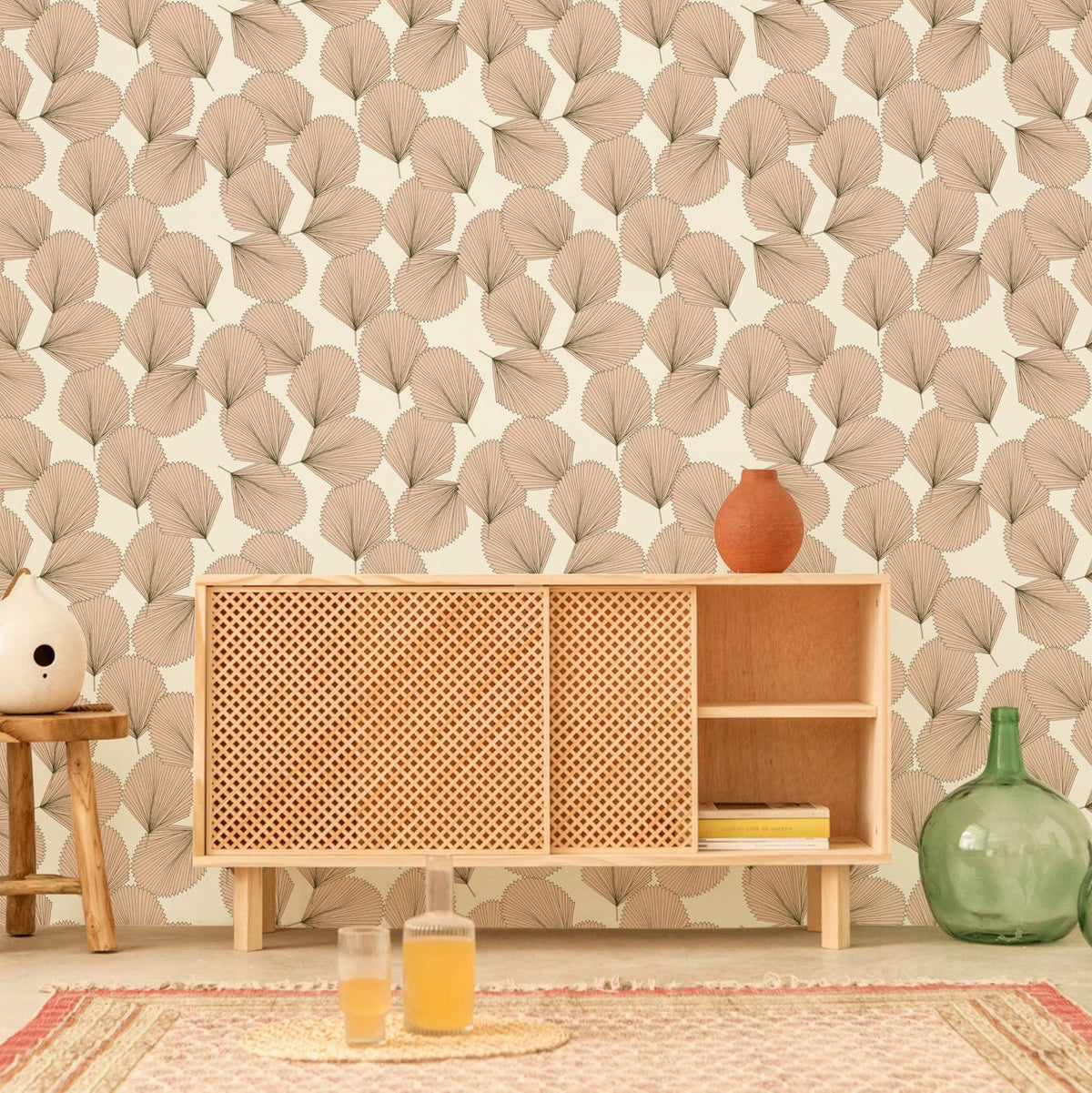 Elegant beige leaf pattern wallpaper in room with teak sideboard and earthy decor elements.