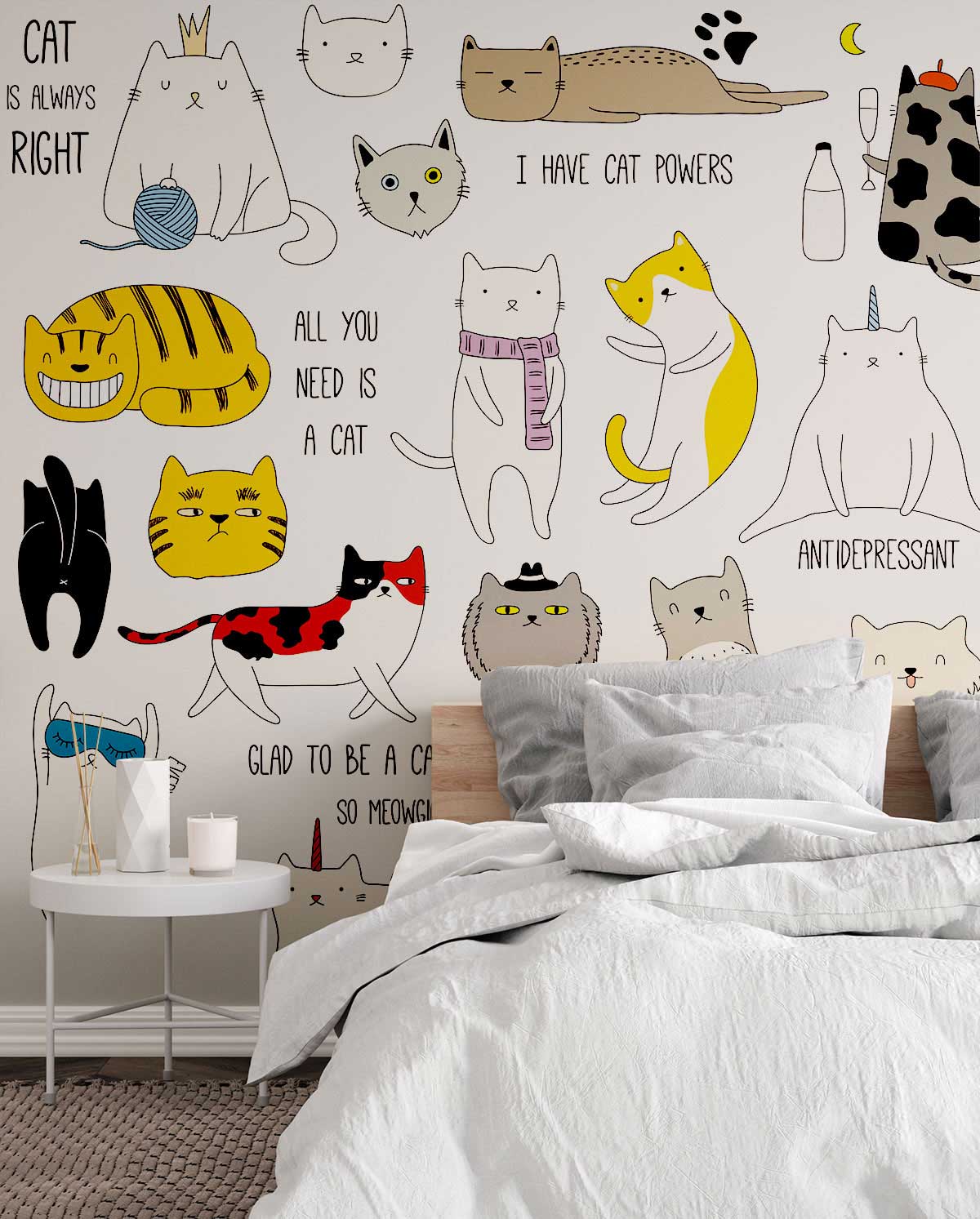 Playful feline mural with cartoon cat quotes decorates kids' room; white bedding, light wooden flooring.