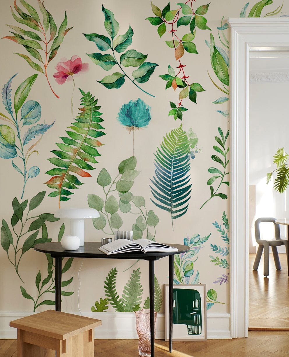 Vibrant botanical wallpaper in green with leaf pattern, black table, modern wooden stool, parquet flooring.