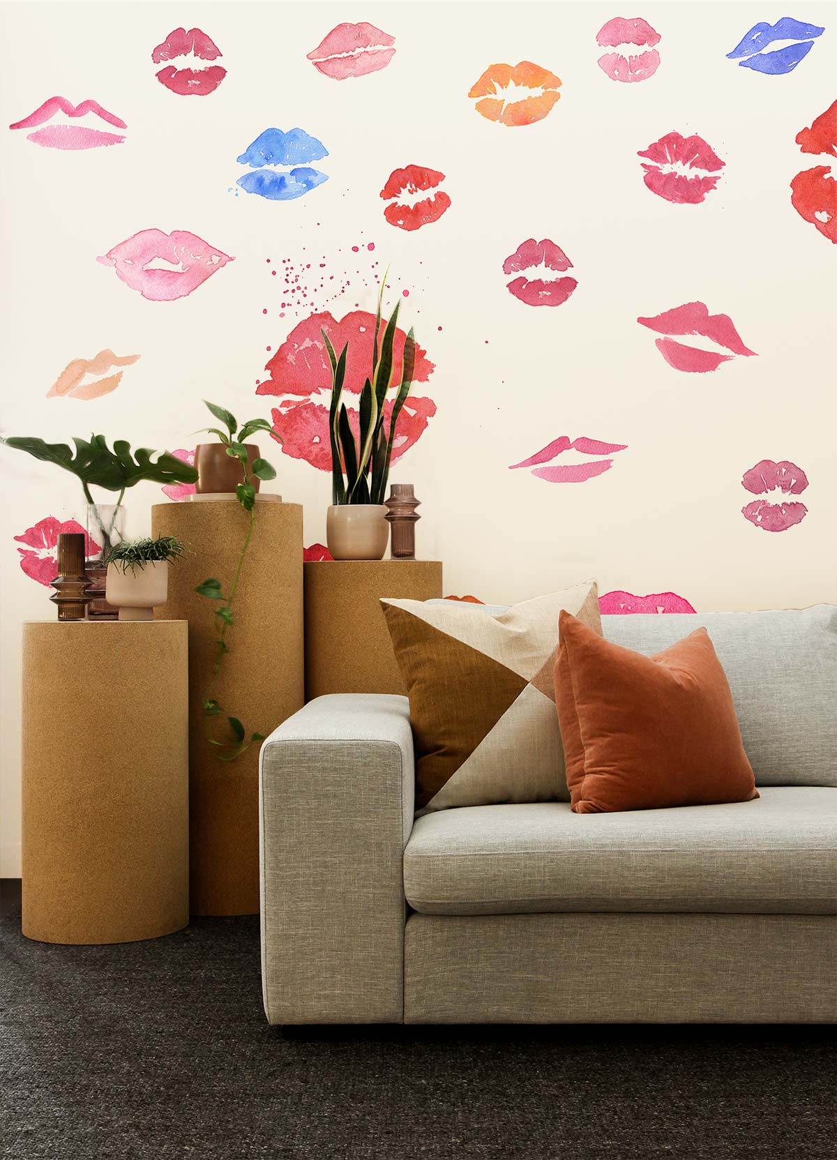 Vibrant Kiss Multicolour Watercolour Lips Wallpaper with light grey sofa, textured flooring, cylindrical stands.