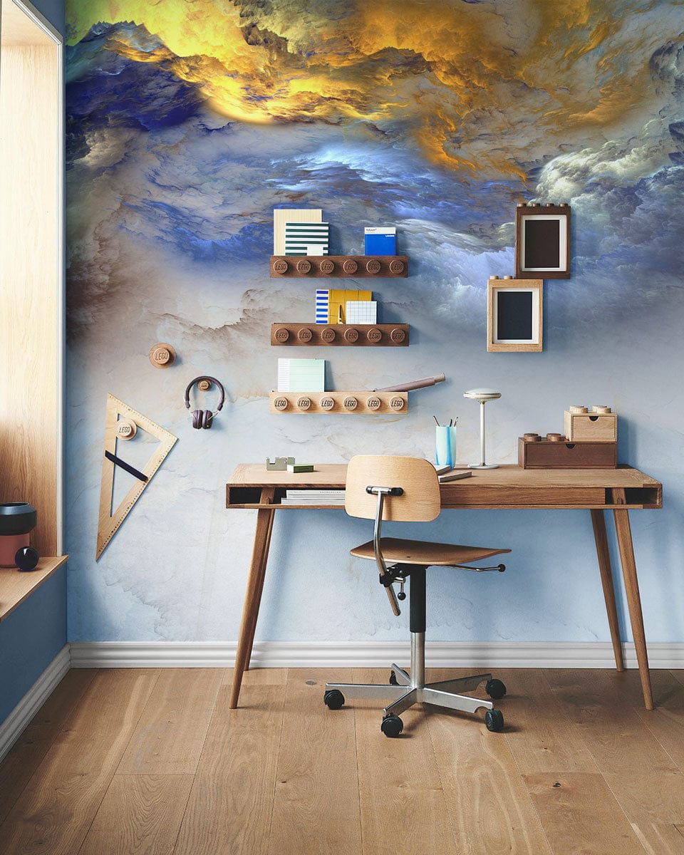 Abstract skyscape mural wallpaper in blue and gold with modern desk, chair, and wooden flooring.