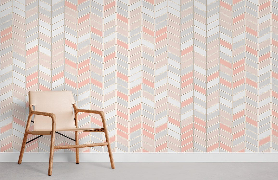 Blush pink and grey chevron wallpaper in contemporary room with beige chair and light grey flooring.