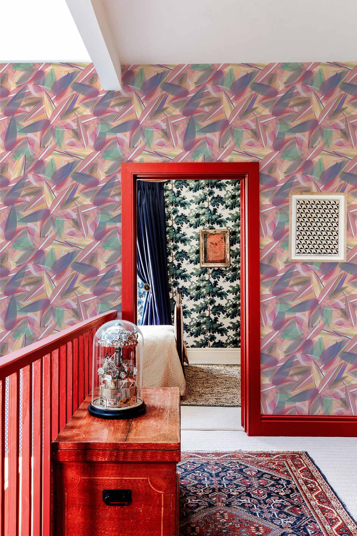 Multicoloured abstract geometric wallpaper with red accents, patterned rug, hallway leading to decorated room.