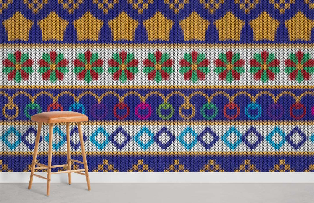 Vibrant multicoloured knitted pattern wallpaper in cosy home decor style, wooden stool on concrete floor.