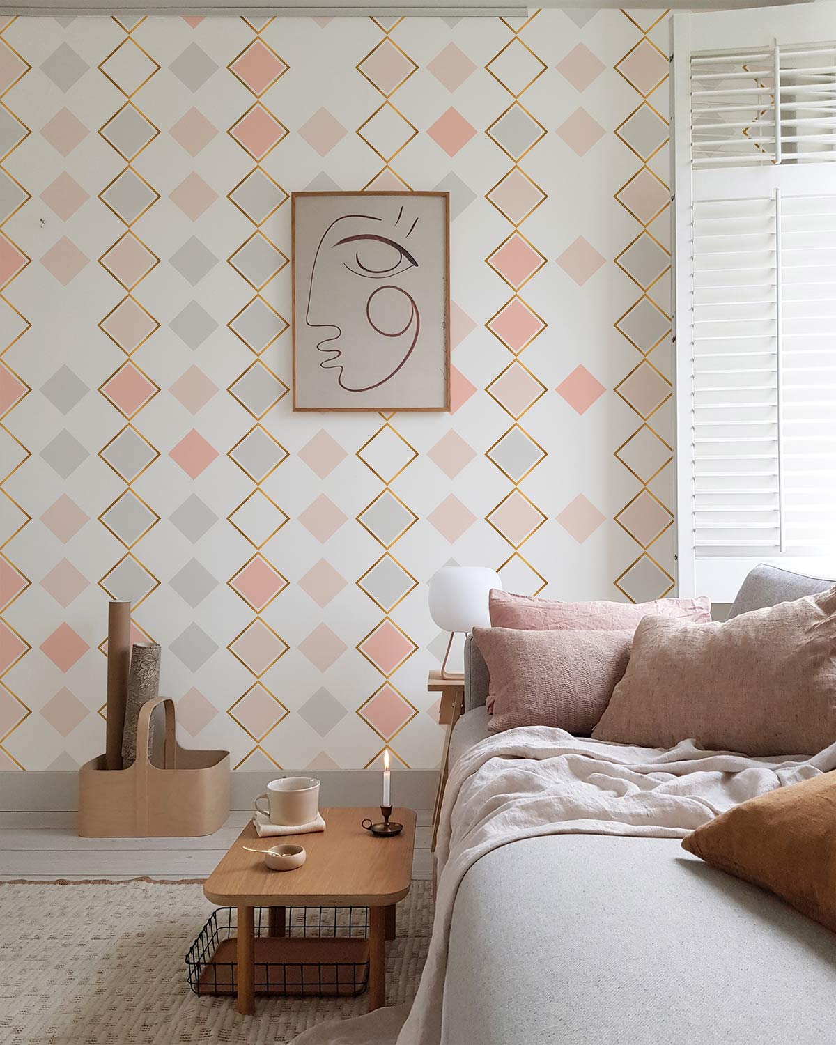 Geometric pastel wallpaper with gold accents, modern art, grey sofa, natural wood table, cosy living room.
