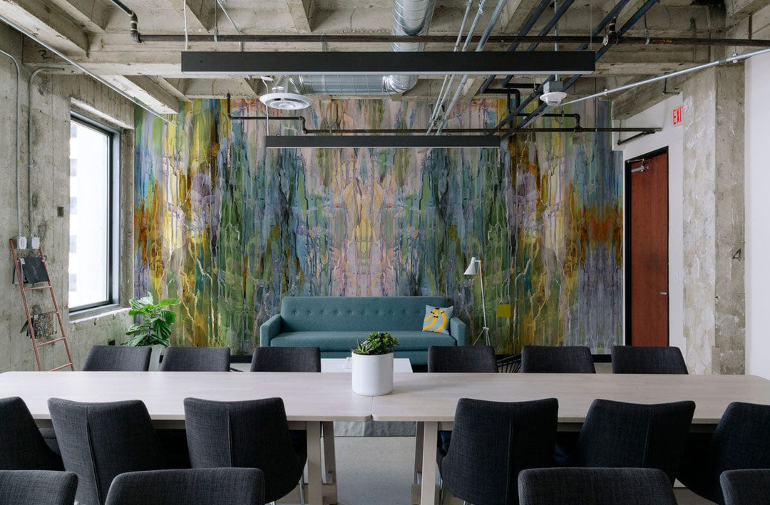 Office with Abstract Watercolour Forest Dream mural wallpaper, stylish blue sofa, grey chairs, modern decor.