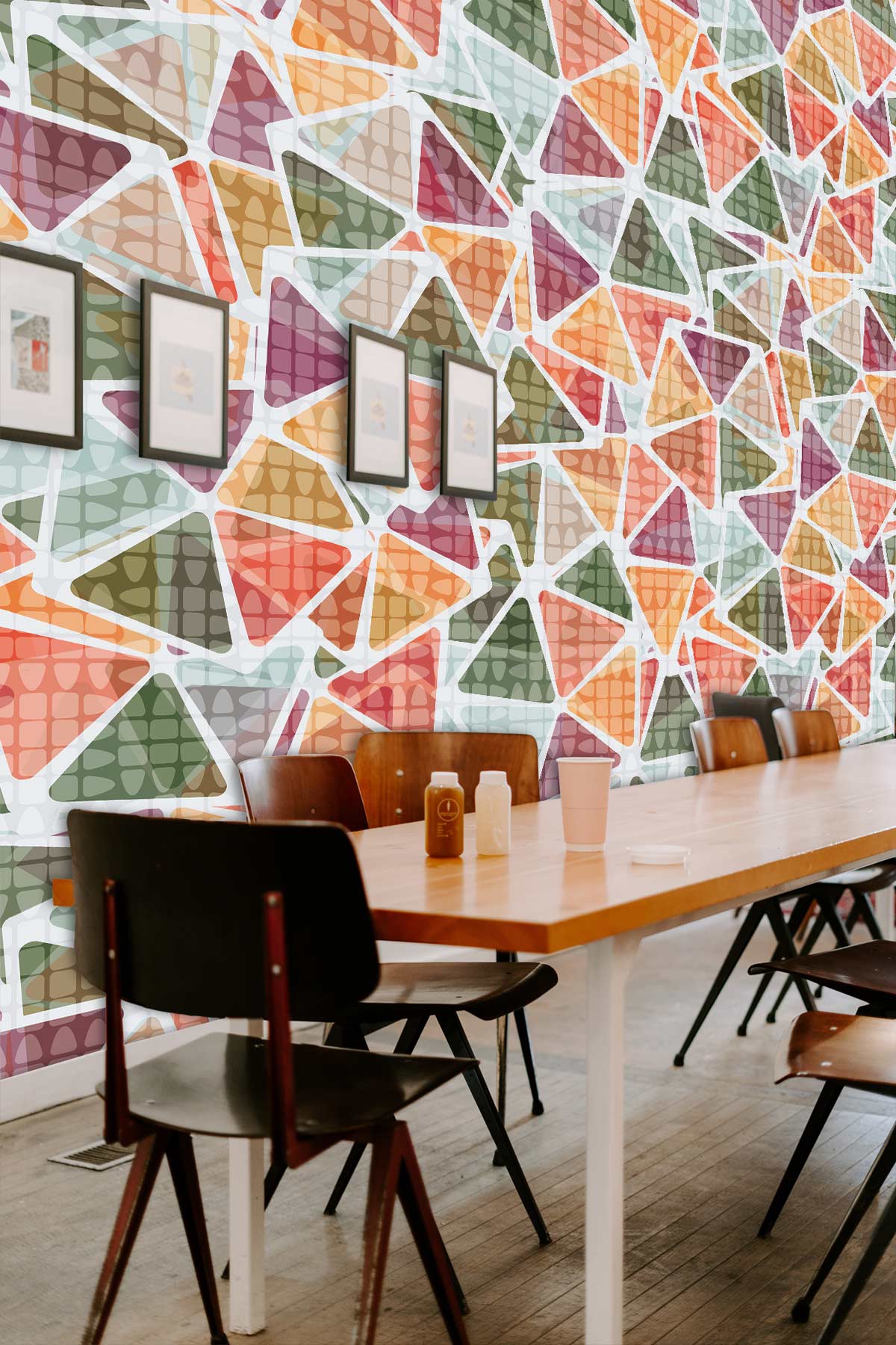 Vintage geometric triangle wallpaper in dining area with wooden table, chairs, and framed artwork.