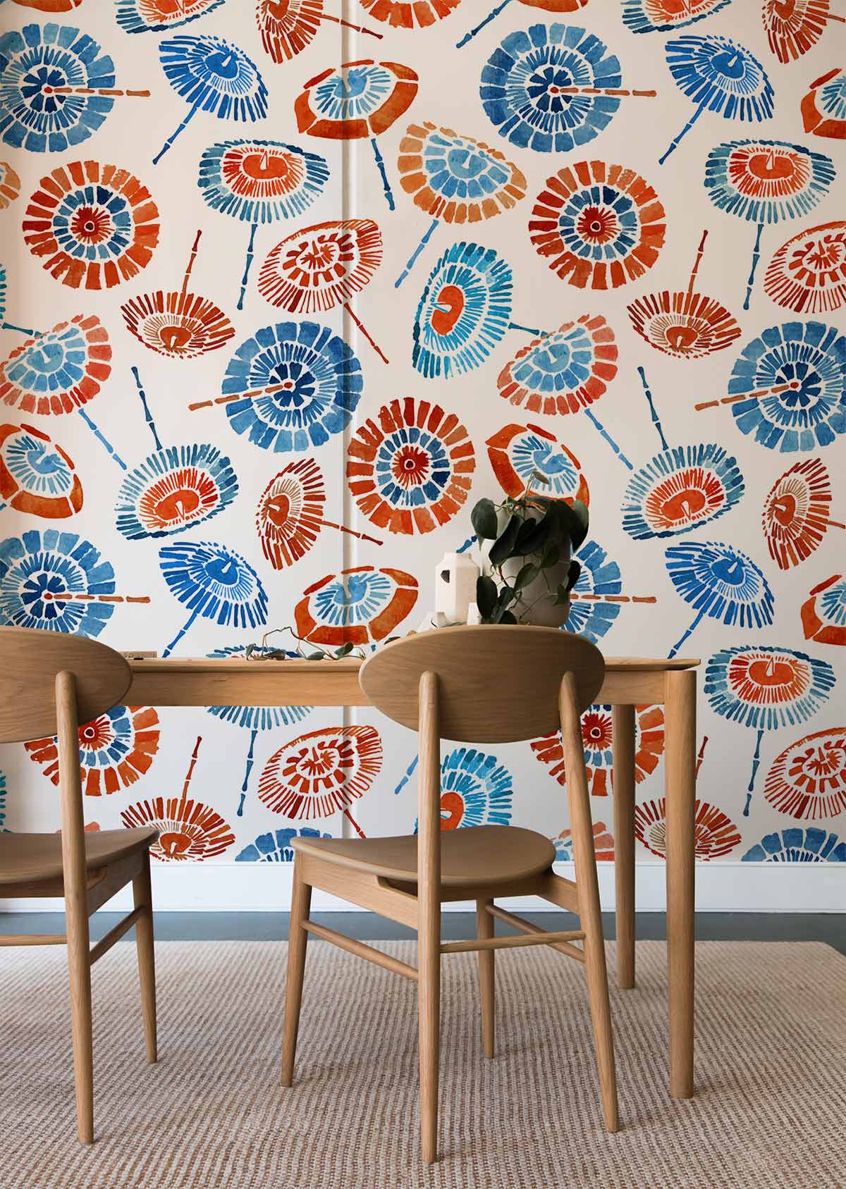 Vibrant geometric fan wallpaper with contemporary design, wooden dining set, neutral carpet in modern room.