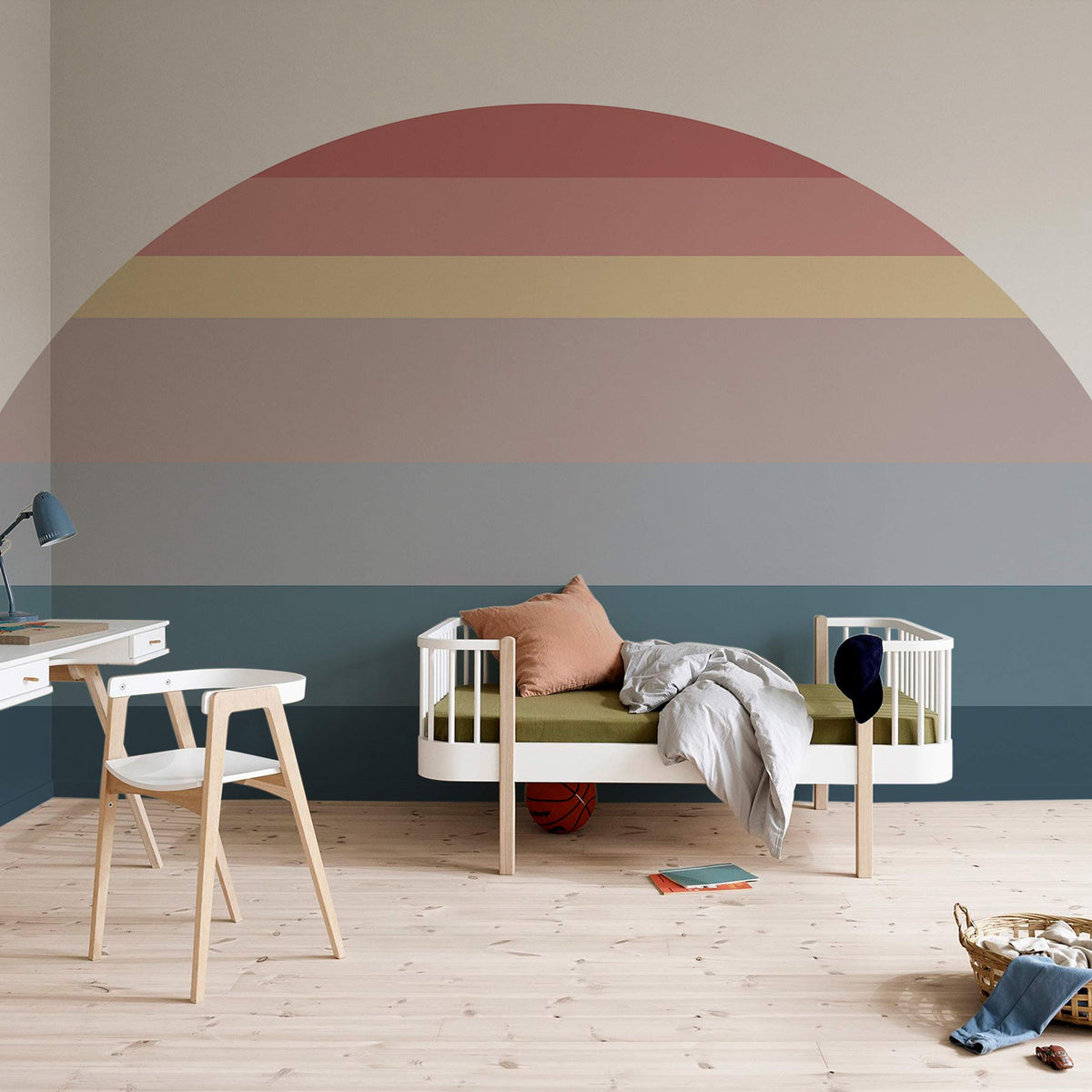 Vintage Sunset Gradient Mural Wallpaper in pastel tones decorates nursery with wooden flooring and furniture.