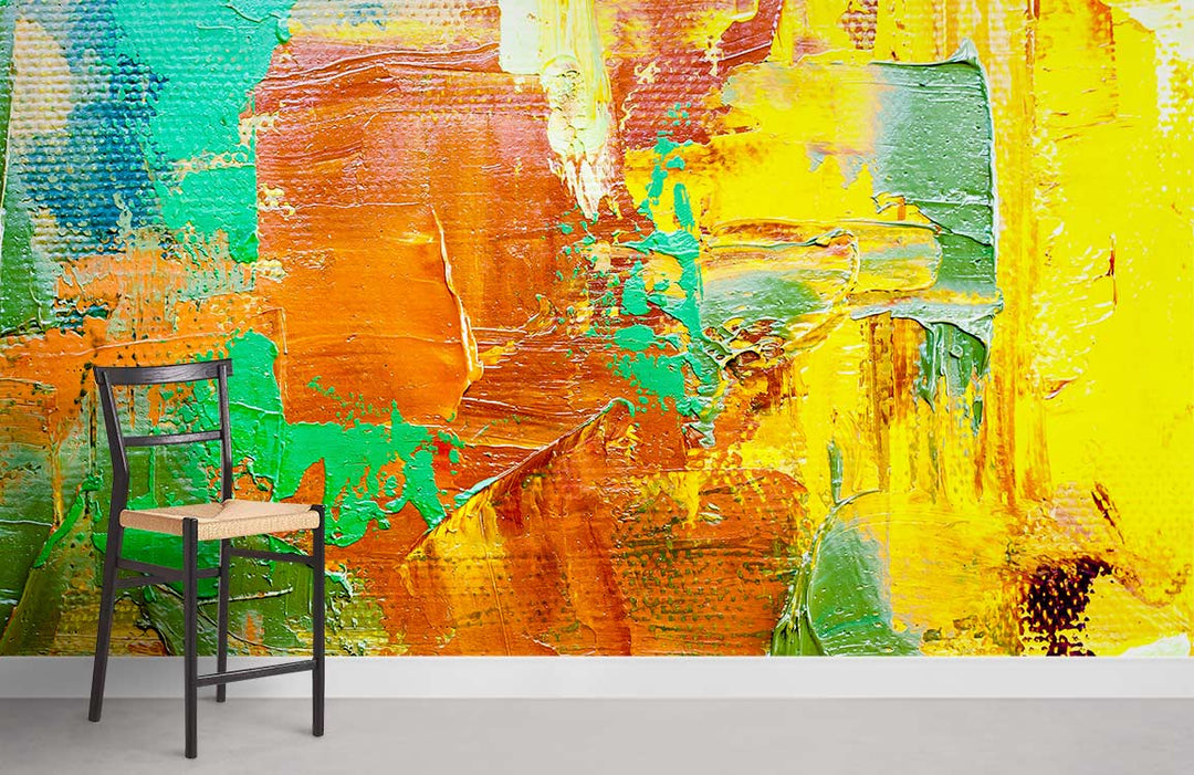 Vibrant abstract mural wallpaper in bold yellow, orange, green, with black chair on grey flooring.
