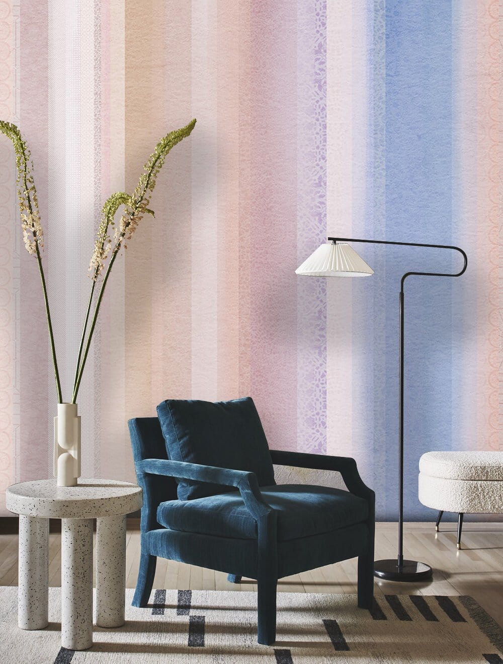 Pastel stripes wallpaper in living room with blue armchair, textured floor lamp, and modern decor.