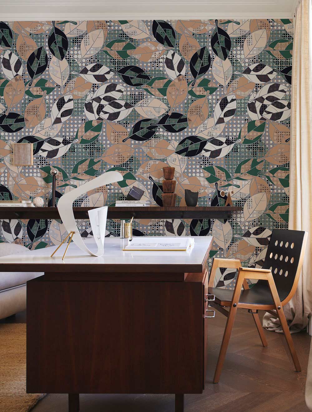 Stunning green and beige geometric leaf wallpaper, featuring desk and wooden chair in modern room.