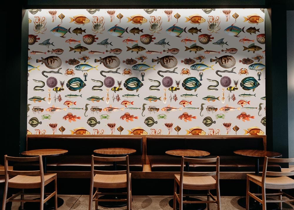 Nautical Coastal Marine Life Wallpaper, earthy tones, wooden furniture, café setting, warm lighting ambiance.