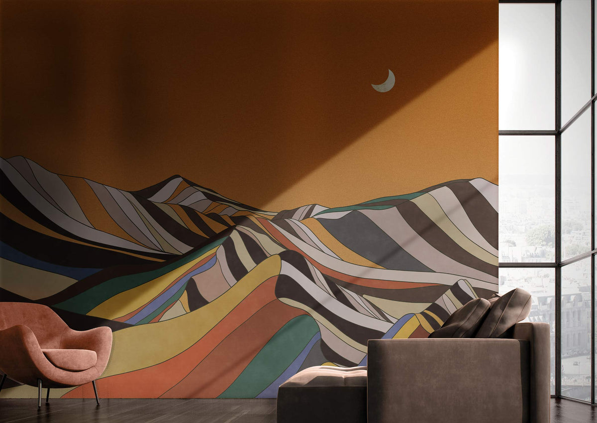 Retro multicolour mountain mural on wall, brown armchair, grey sofa, dark wooden flooring, modern room.