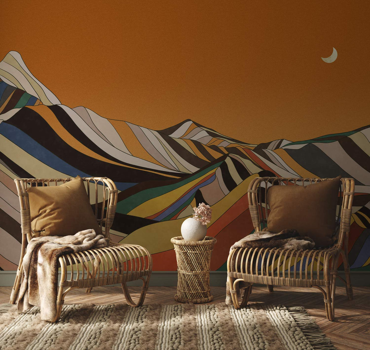 Retro sunset mountain mural wallpaper with rattan chairs, chevron rug, in a warm-toned living room.