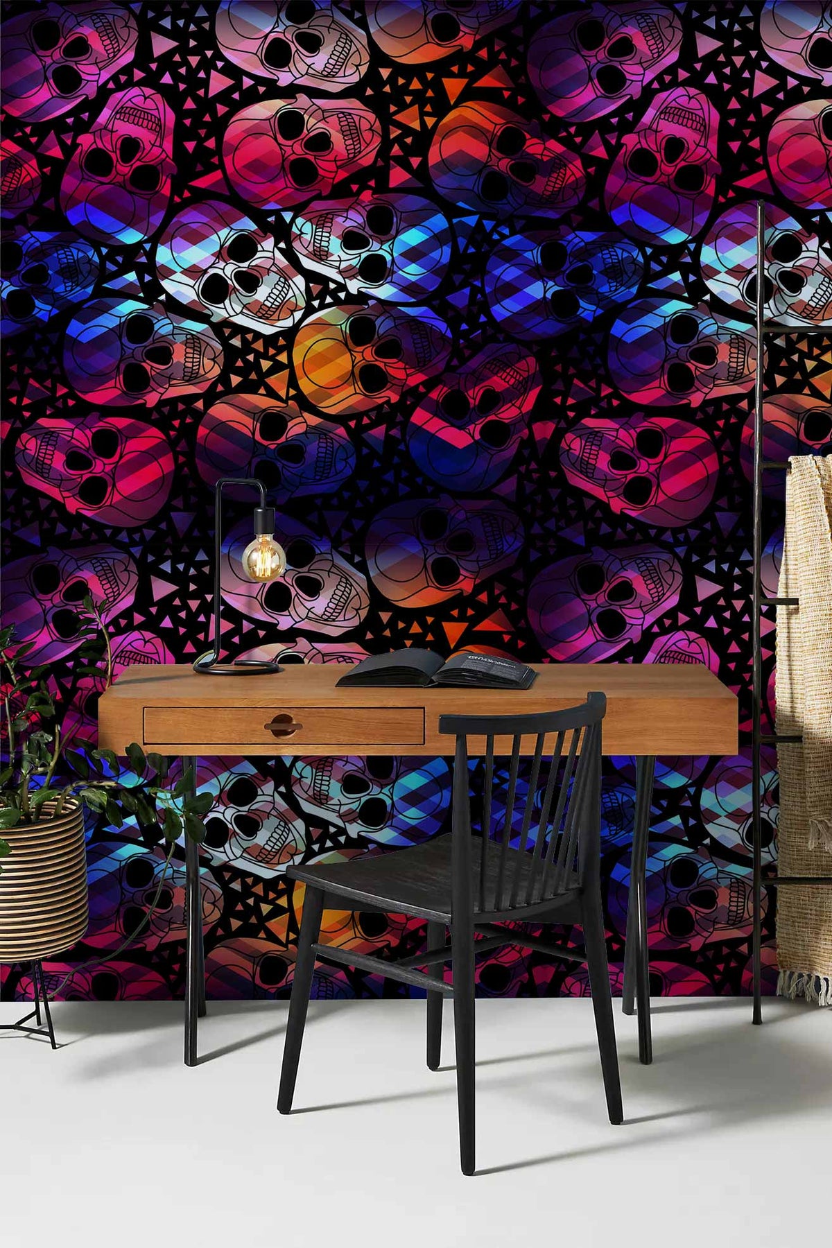 Vibrant geometric skull wallpaper, bold multicolour; wooden desk, black chair, contemporary style room.