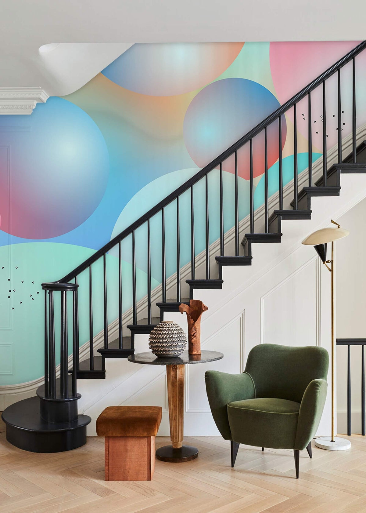Modern staircase with Pastel Dreamscape Bubble Theme Mural, green armchair, wooden flooring, elegant decor.