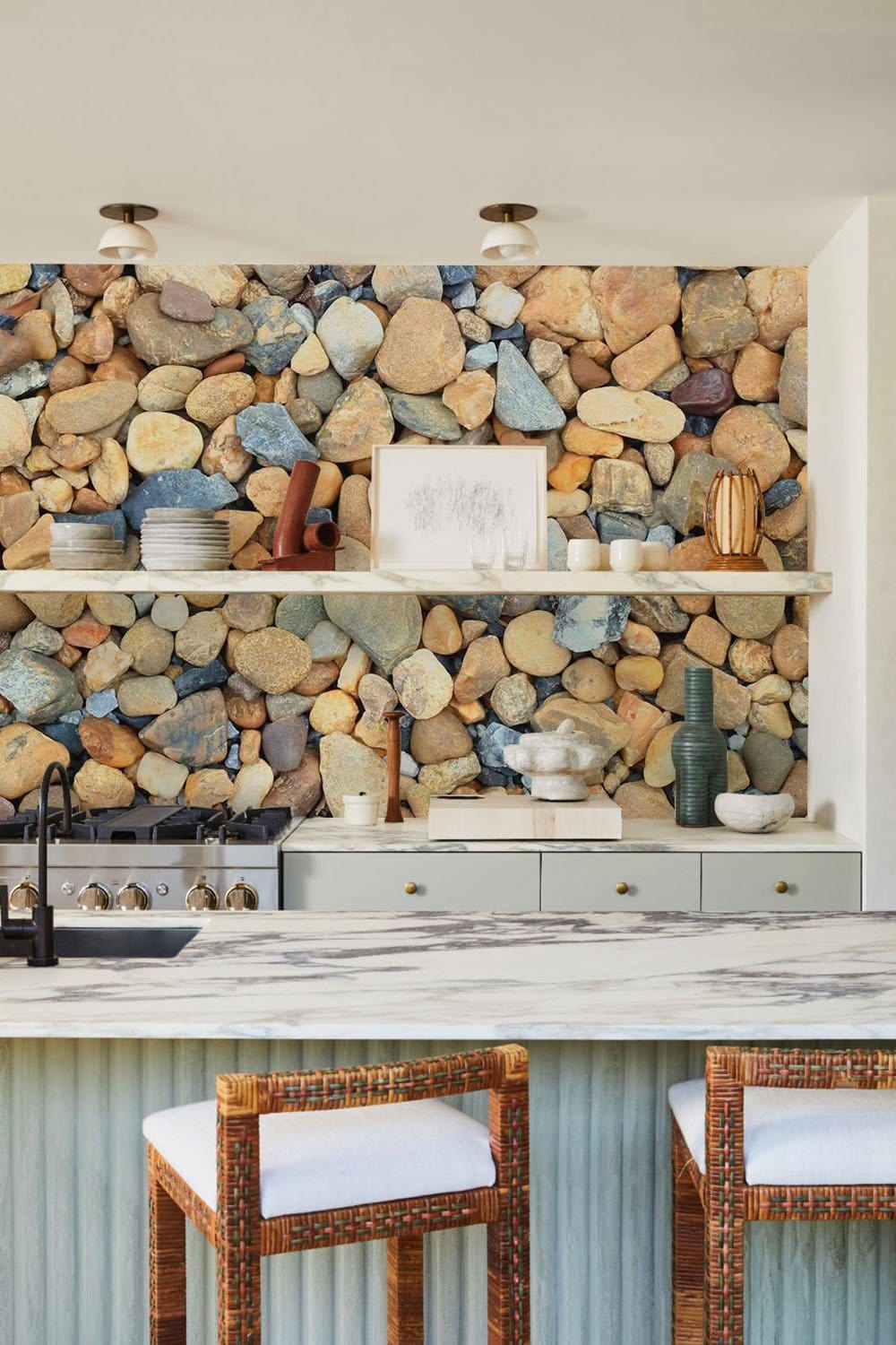 Natural Pebble Stone Texture wallpaper in rustic grey tones, kitchen decor with marble counter and stools.