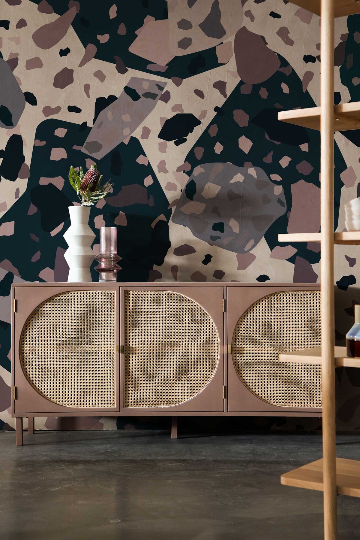 Modern Abstract Terrazzo Wallpaper with mauve sideboard in stylish living room, featuring dark flooring.