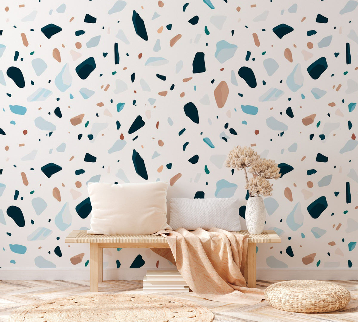 Modern Terrazzo Patterned Wallpaper, blue earthy tones, wooden bench, neutral cushions, light wood flooring.