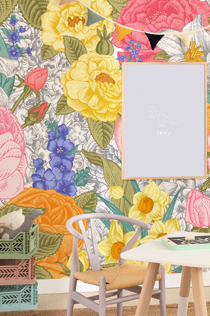 Vibrant Floral Paradise mural wallpaper with colourful flowers, wooden chair, and minimalist table in bright room.